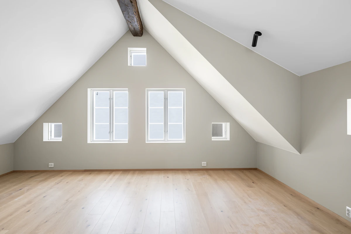 Finished loft interior with vaulted ceiling and rooflights