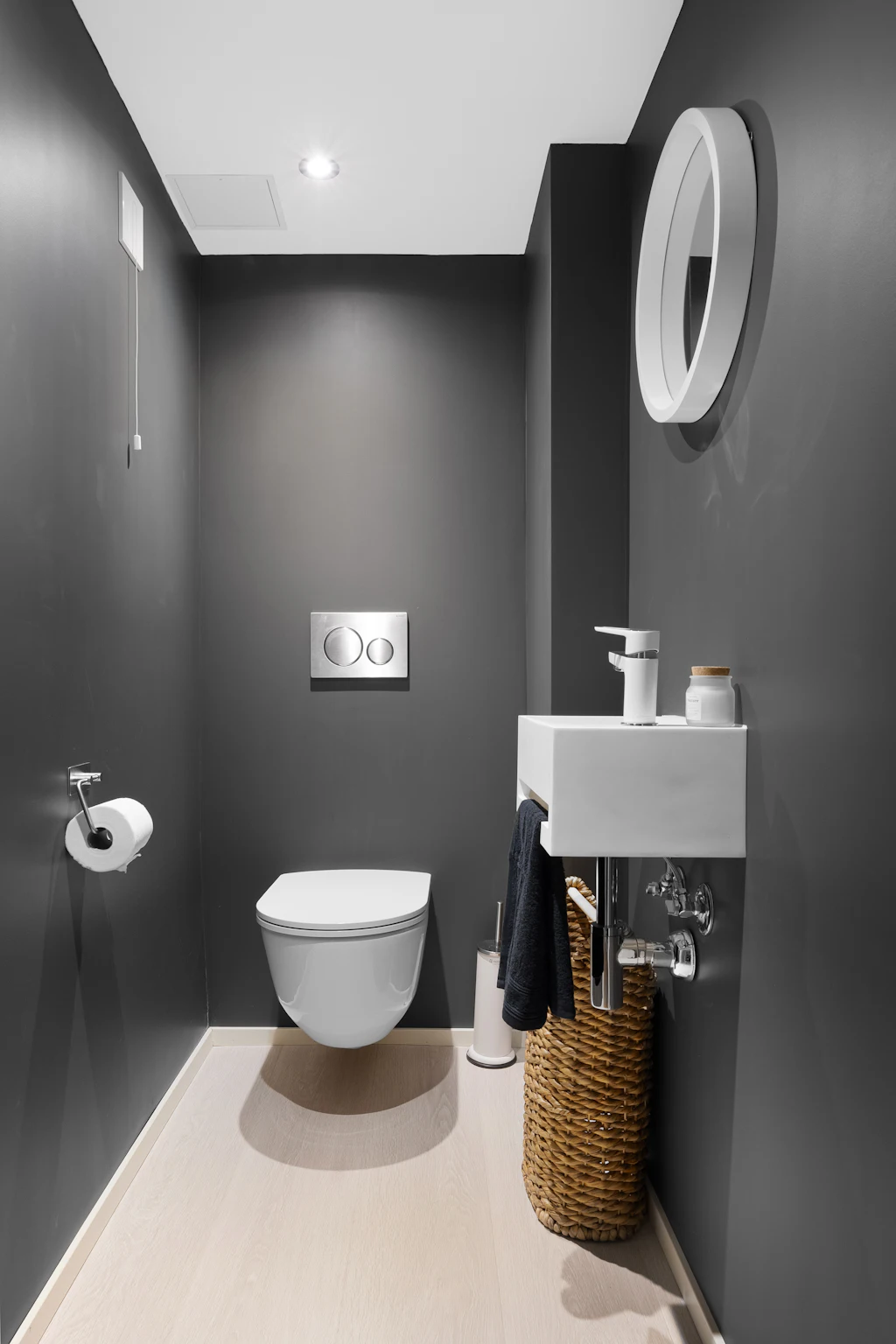 A toilet and small sink in a bathroom, illustrating the setting rather than a bidet device