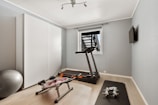A home gym with a treadmill and exercise equipment
