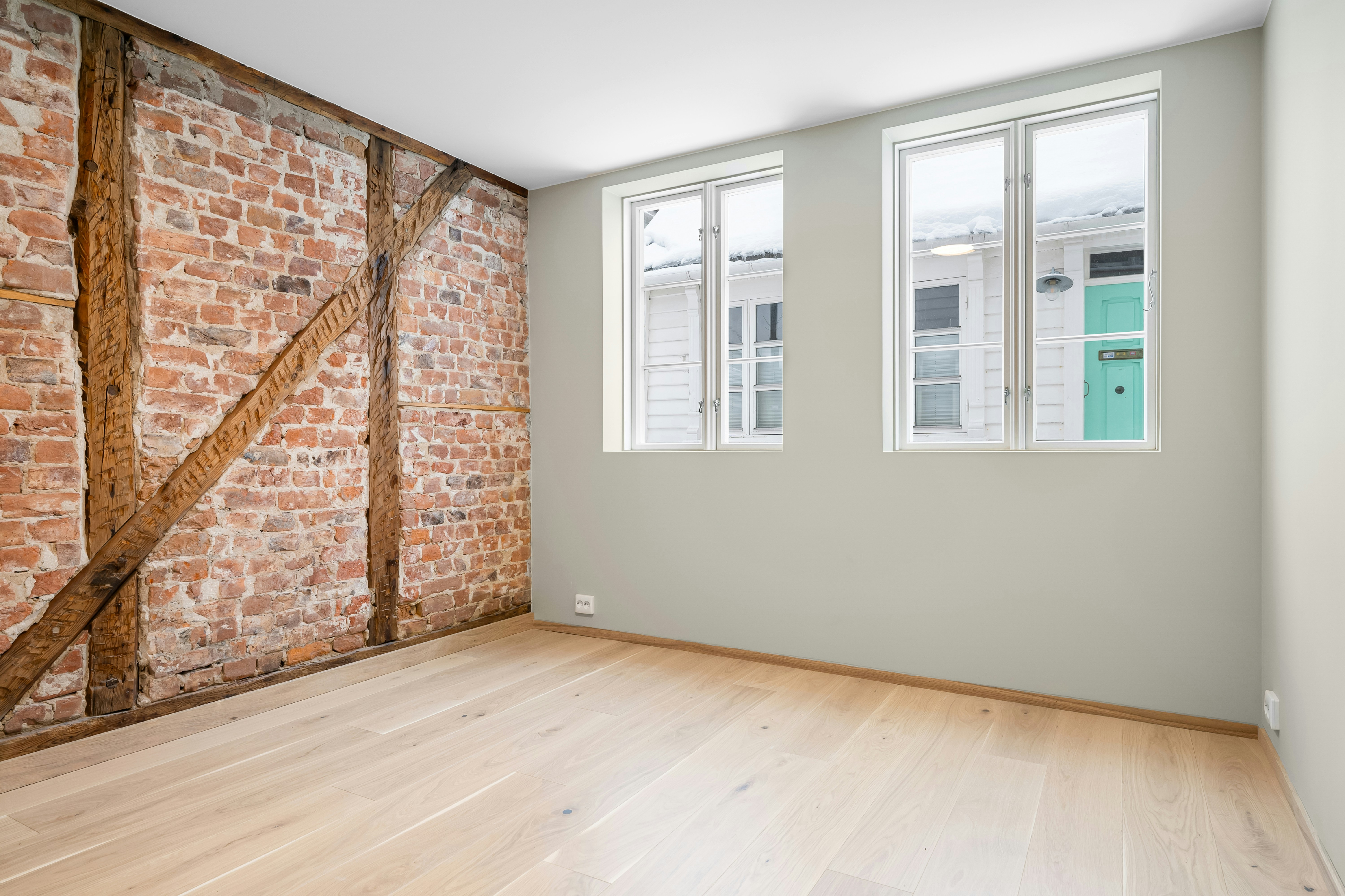Empty room with exposed brick wall