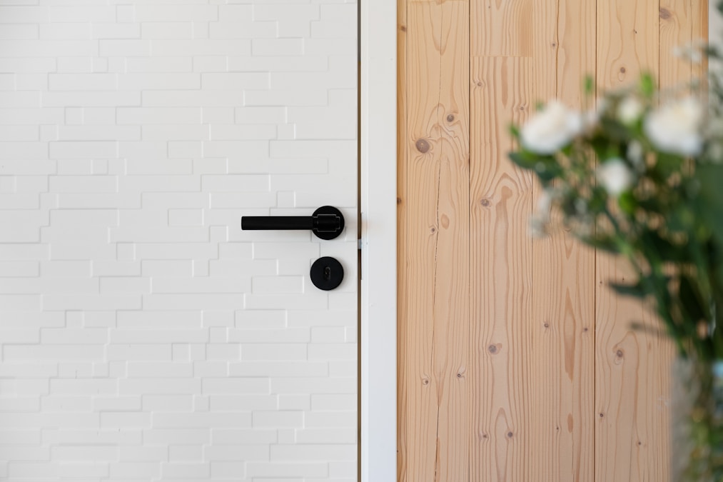 OKUN matte black privacy door lever with round rosette — solid-core interior door hardware for general contractors
