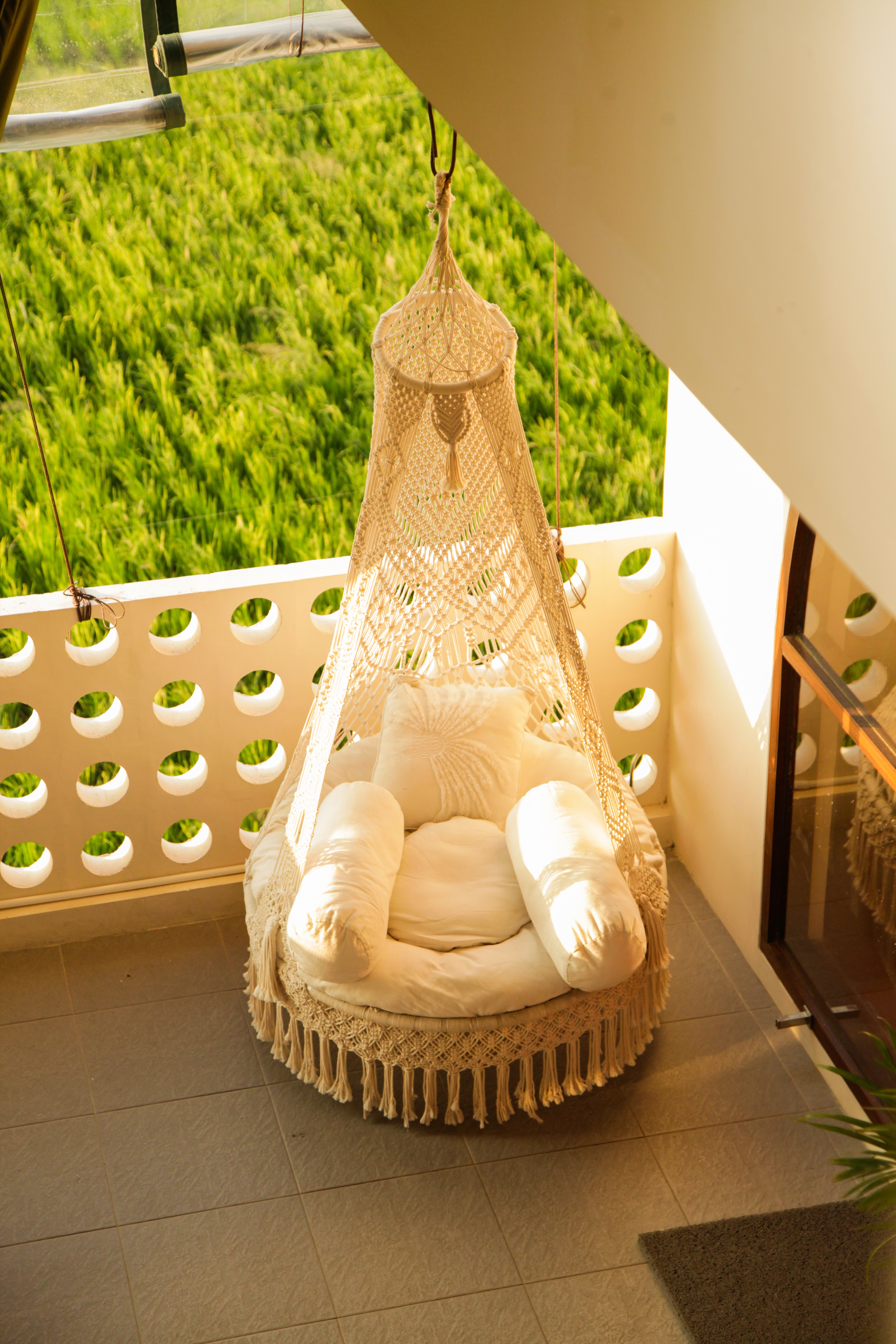 A hammock hanging from the side of a building