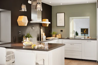 A kitchen with a center island and white cabinets
