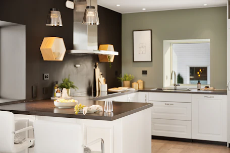 A kitchen with a center island and white cabinets