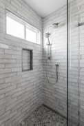 A walk in shower sitting next to a window