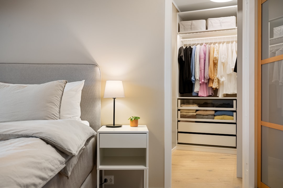 organized bedroom closet with hanging clothes and folded items in drawers