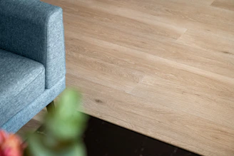 A blue chair sitting on top of a wooden floor