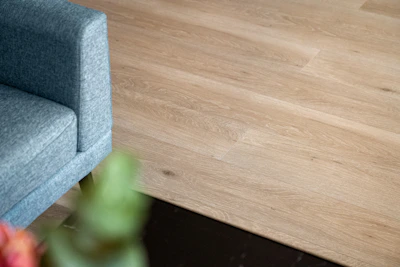 A blue chair sitting on top of a wooden floor