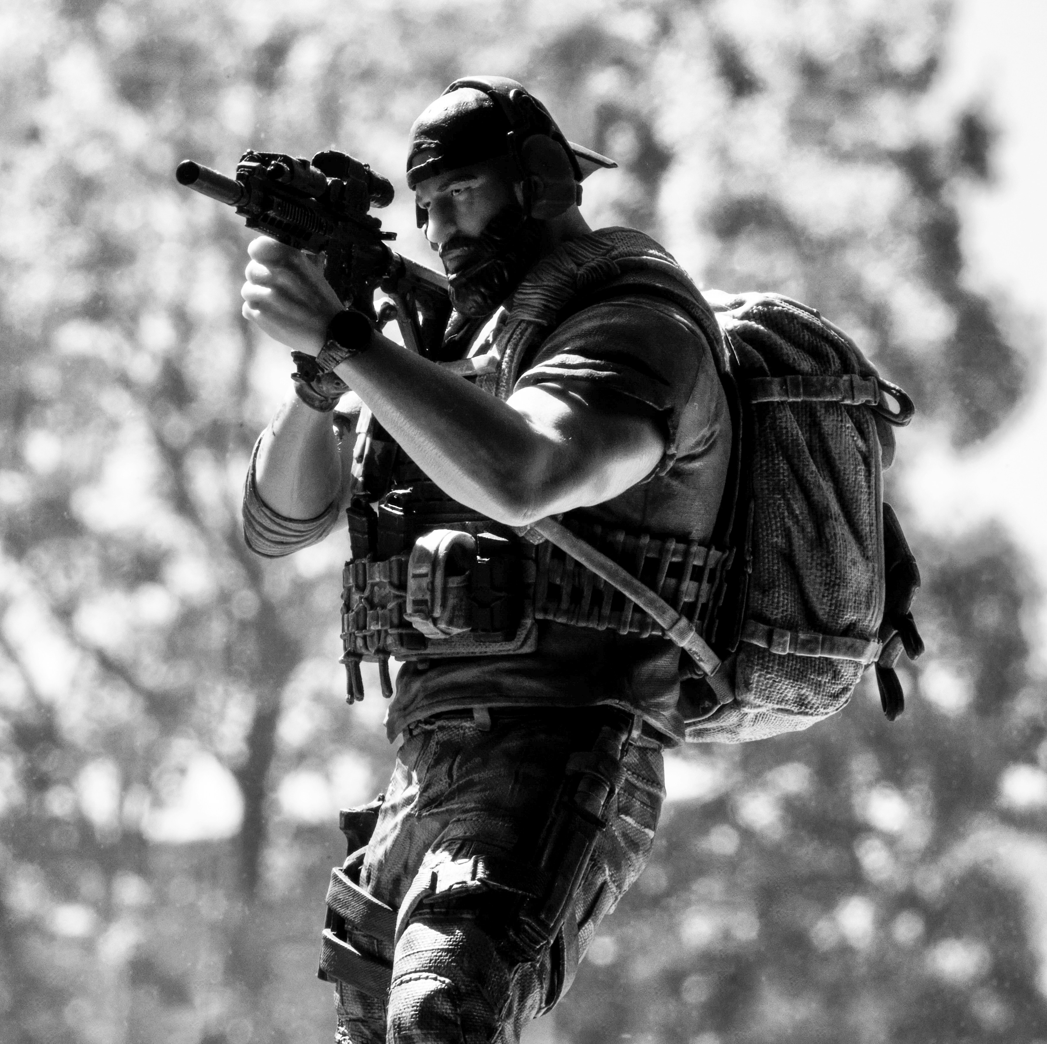 A man with a backpack is holding a gun