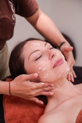 A woman getting a facial mask on her face