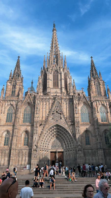 A group of people standing in front of a large cathedral