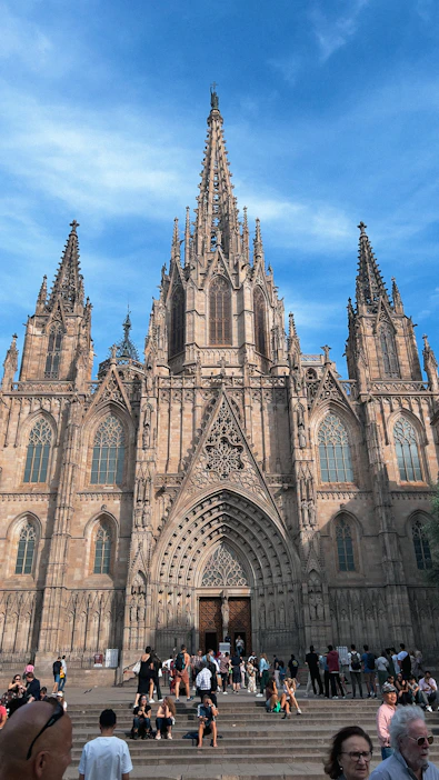 A group of people standing in front of a large cathedral