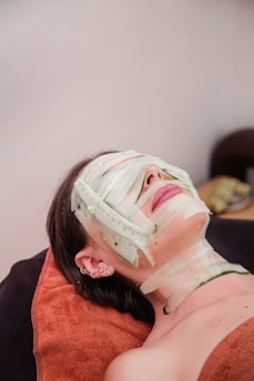 A woman laying down with a mask on her face