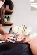 A man getting a facial mask on his face