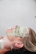 A woman with a cucumber on her face