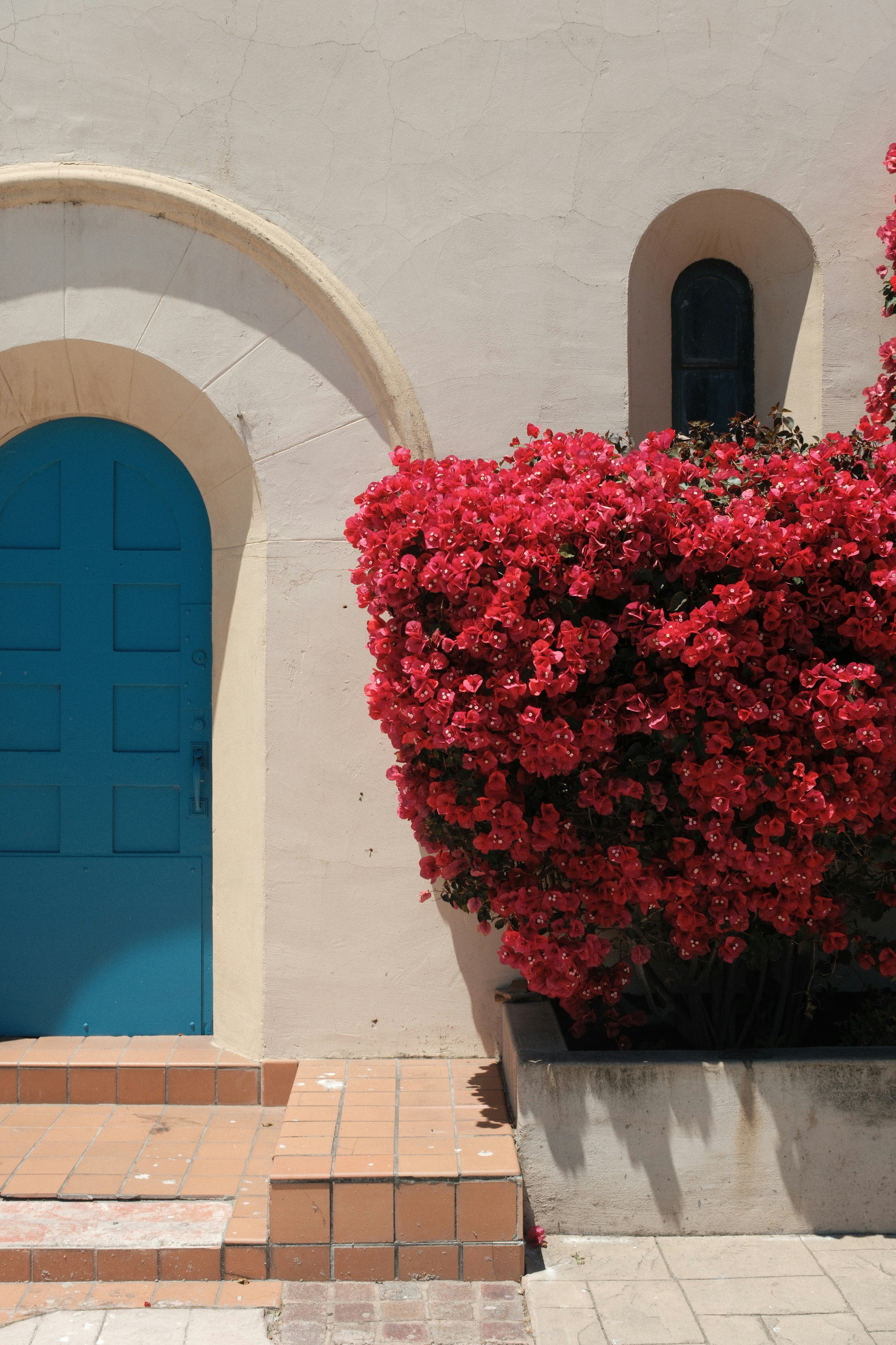 A blue door and a white building with a blue door