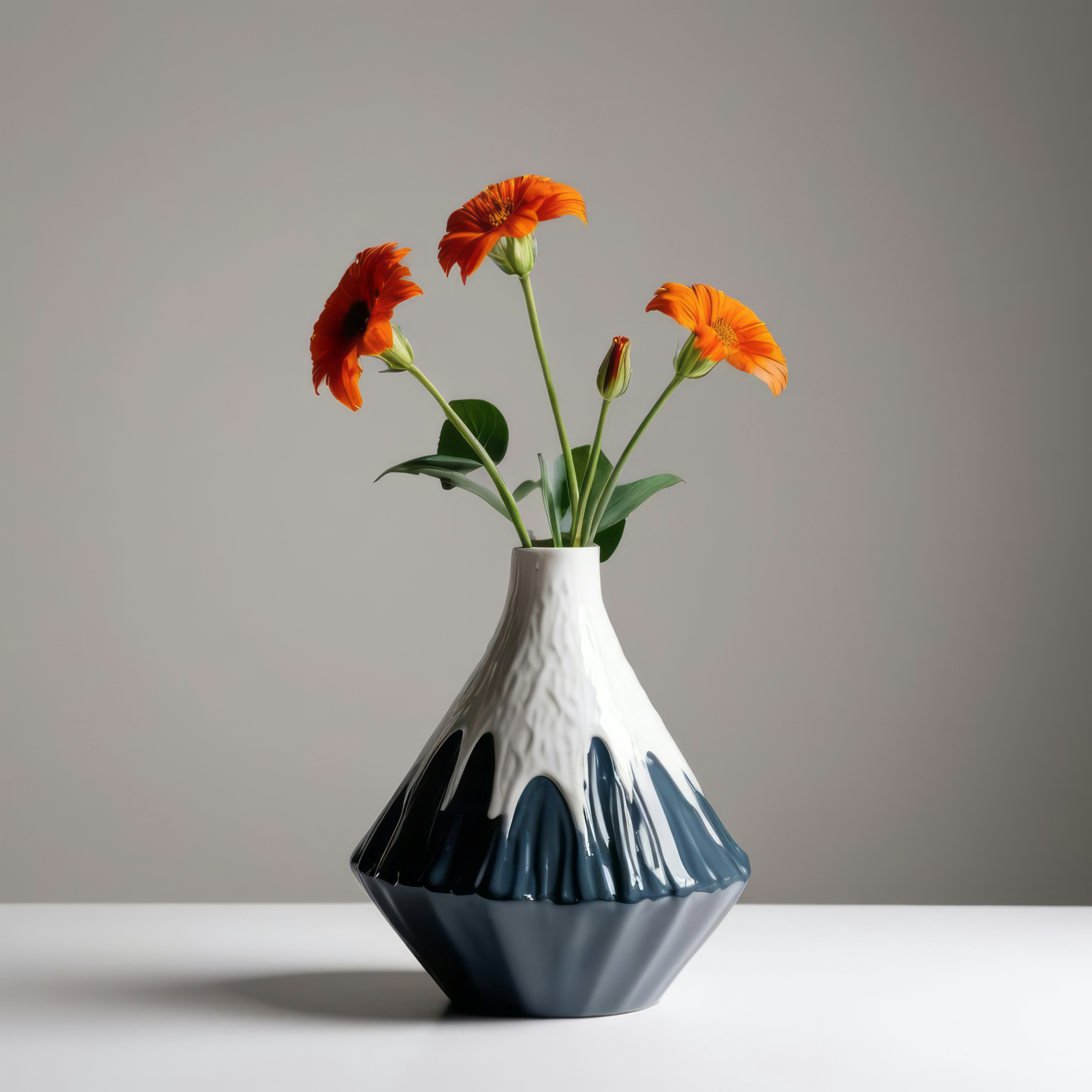 A white and blue vase with orange flowers in it