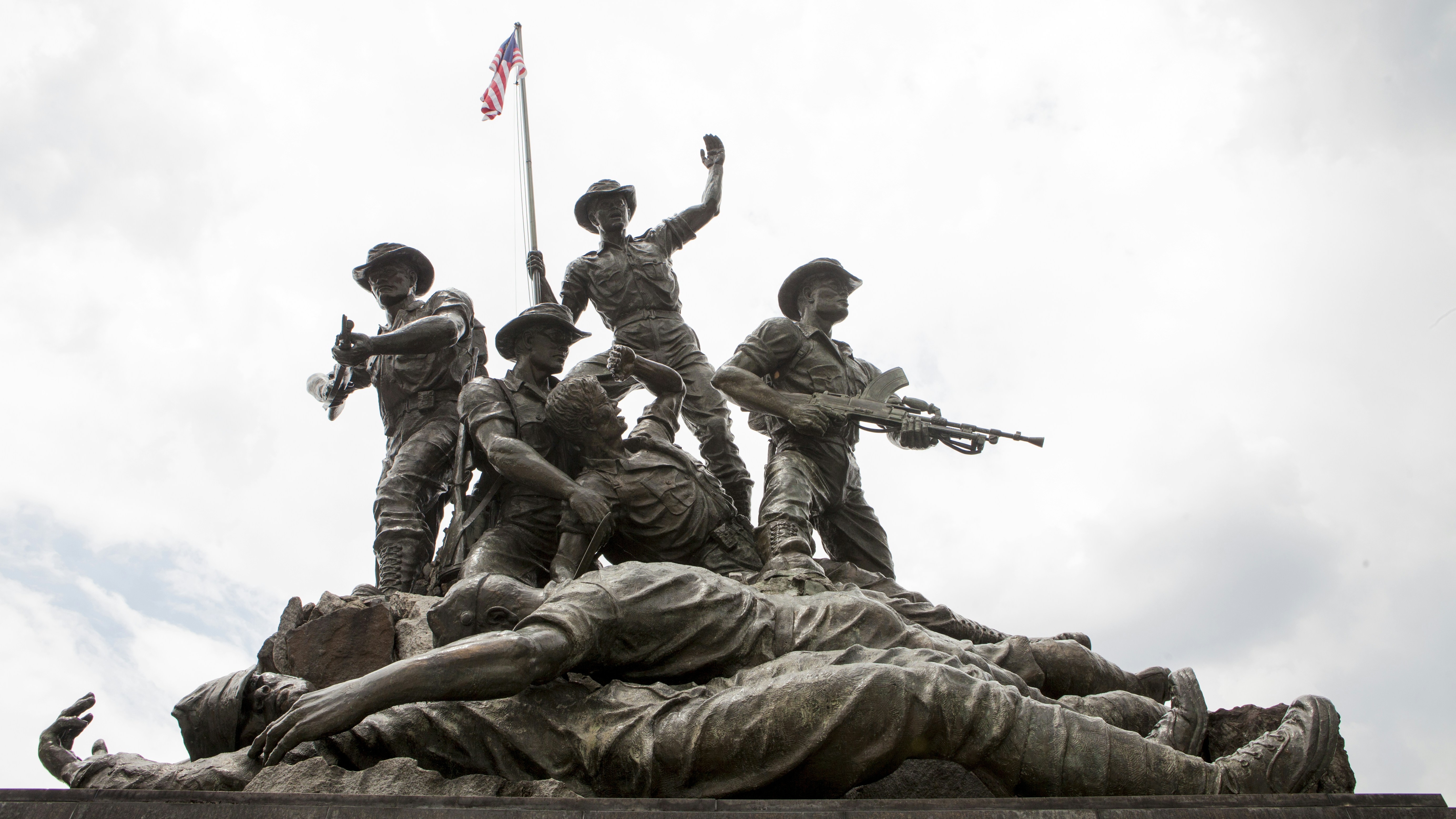 A group of soldiers standing on top of a statue