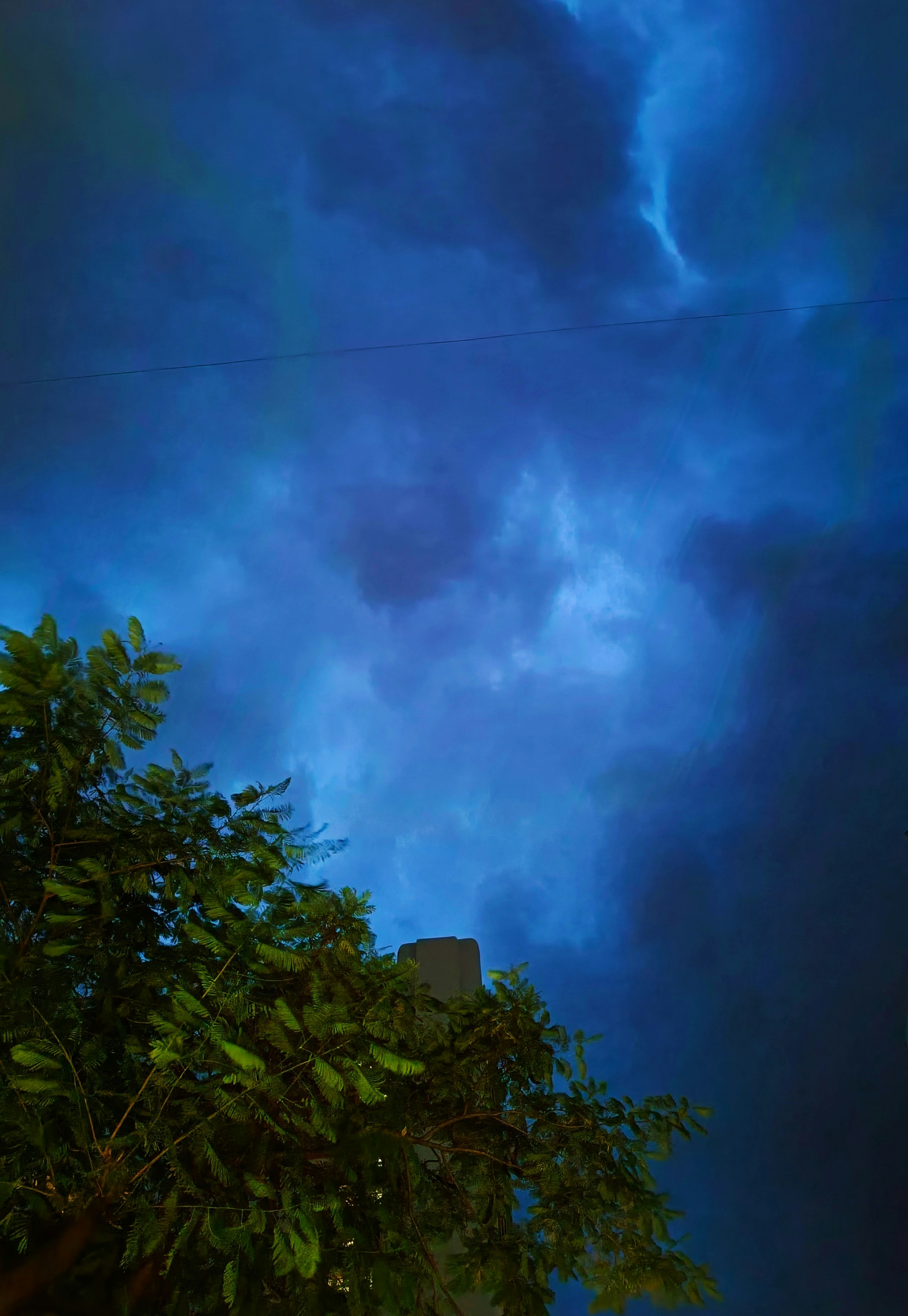 A blue sky with clouds and a tree in the foreground photo – Free Night ...