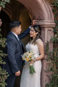 A bride and groom standing in a doorway