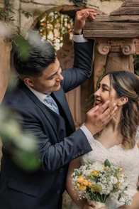 A bride and groom posing for a picture
