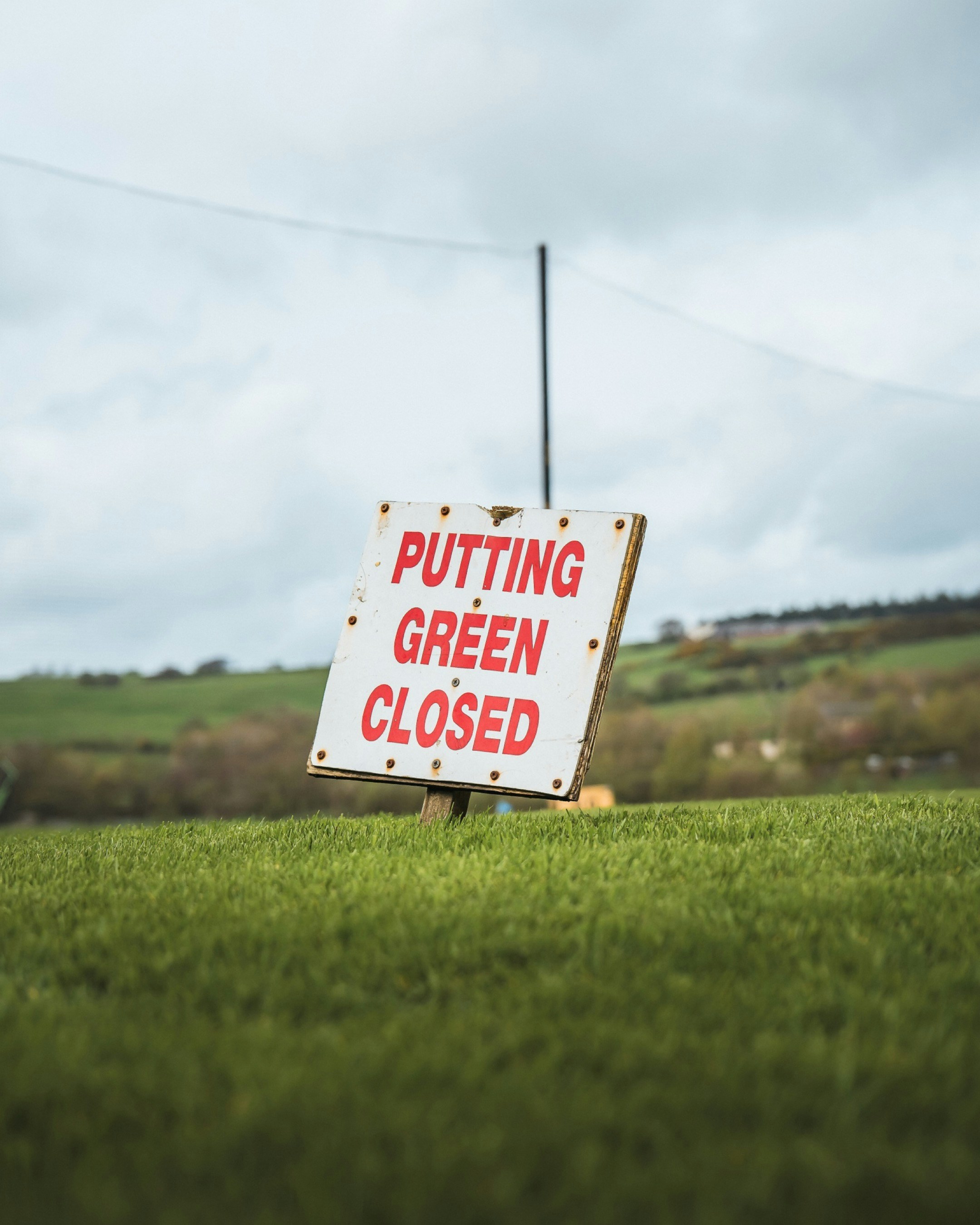 A sign that is sitting in the grass