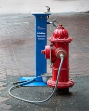 A red and blue fire hydrant on a sidewalk