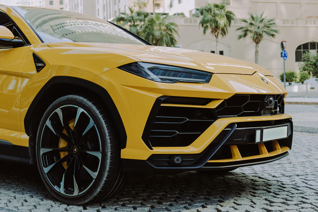 Yellow Lamborghini Urus on a cobbled street