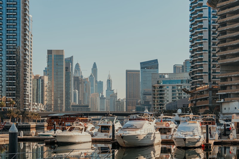 Upscale waterfront with luxury yachts and high-rise buildings