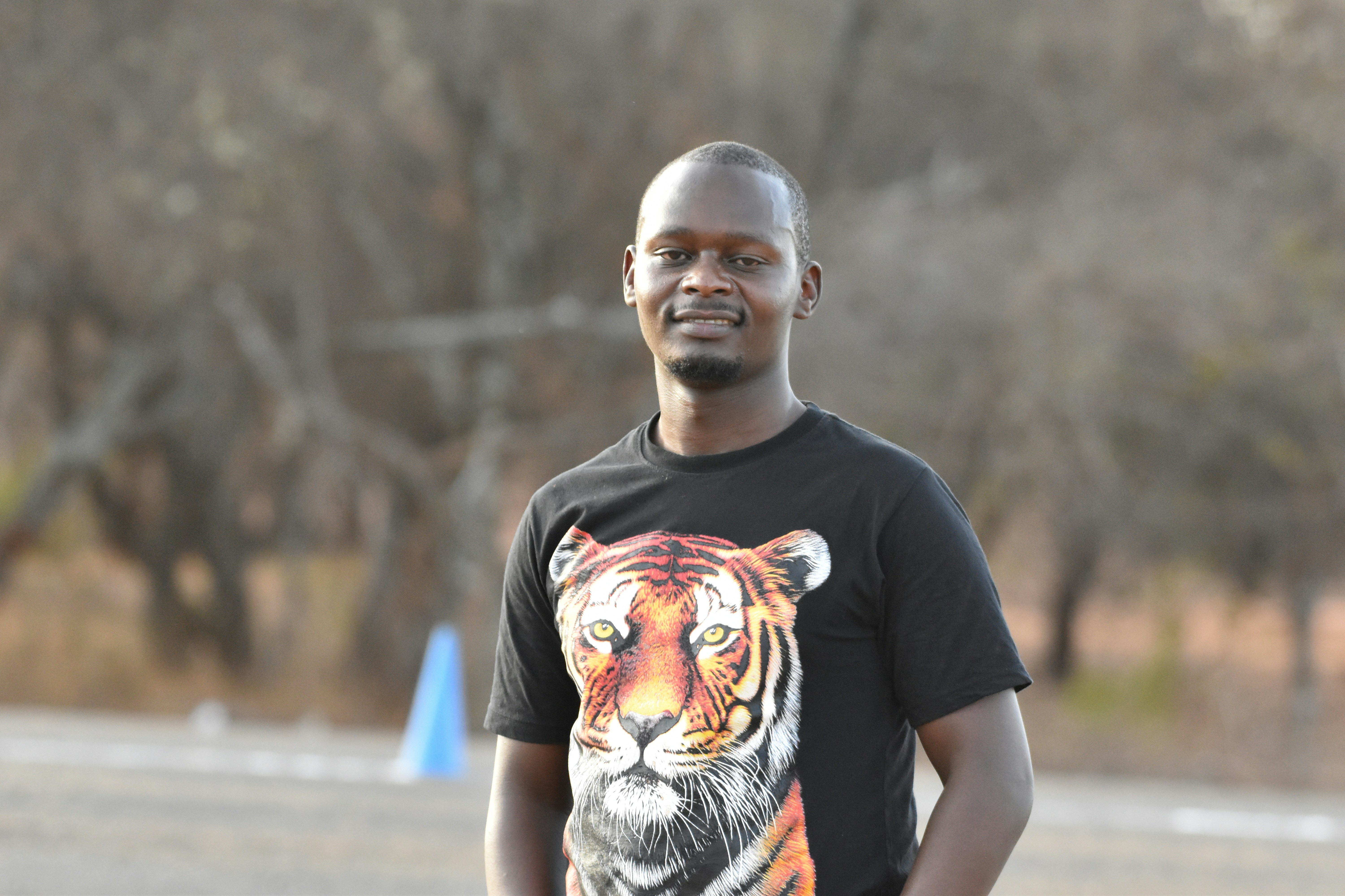 A man standing in the street with a tiger t - shirt on