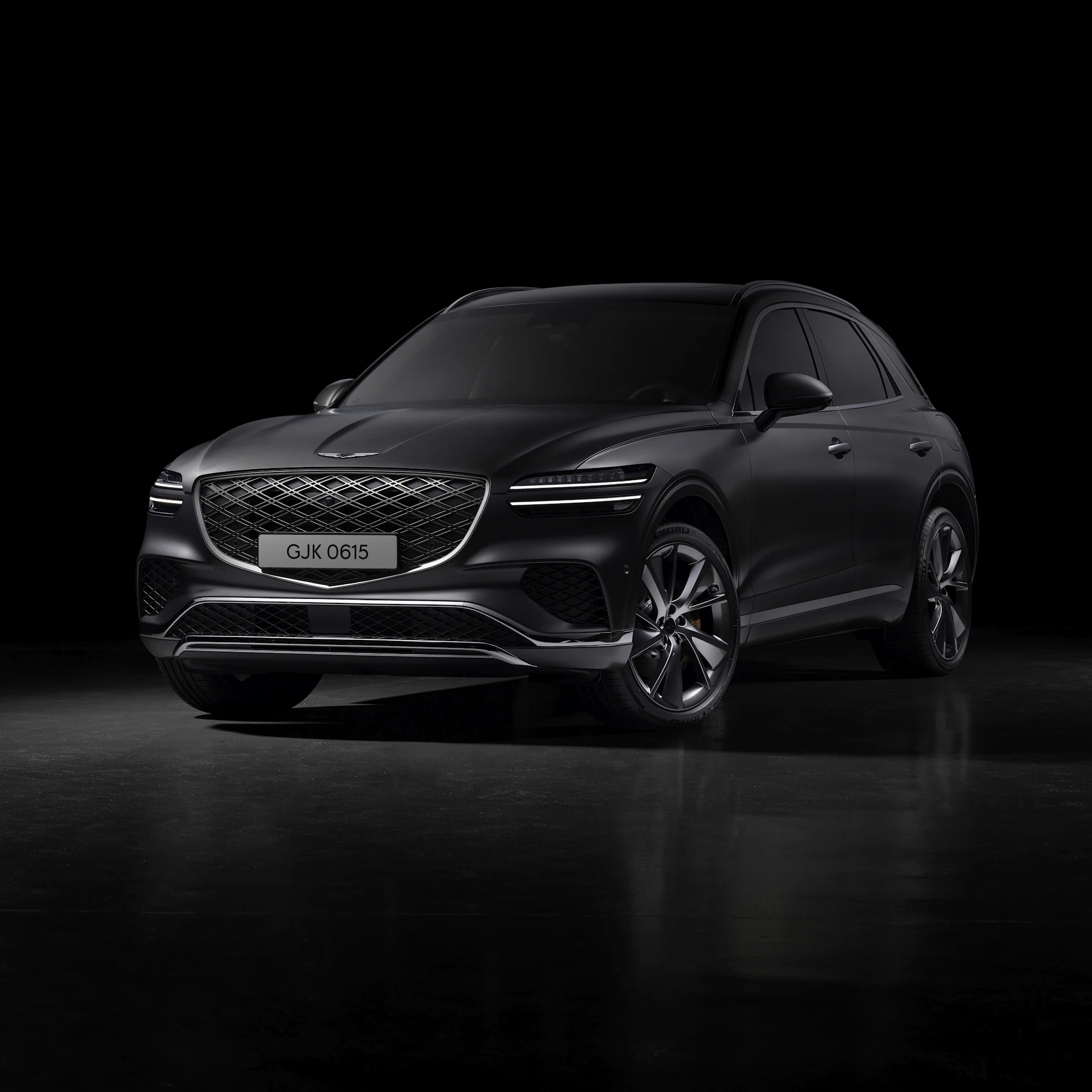 Glossy black car in a dark studio