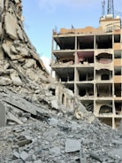 A large building that has a bunch of rubble in front of it