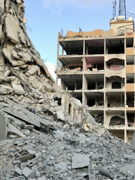 A large building that has a bunch of rubble in front of it