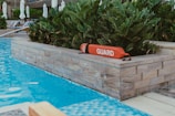 A pool with a guard sign in the middle of it