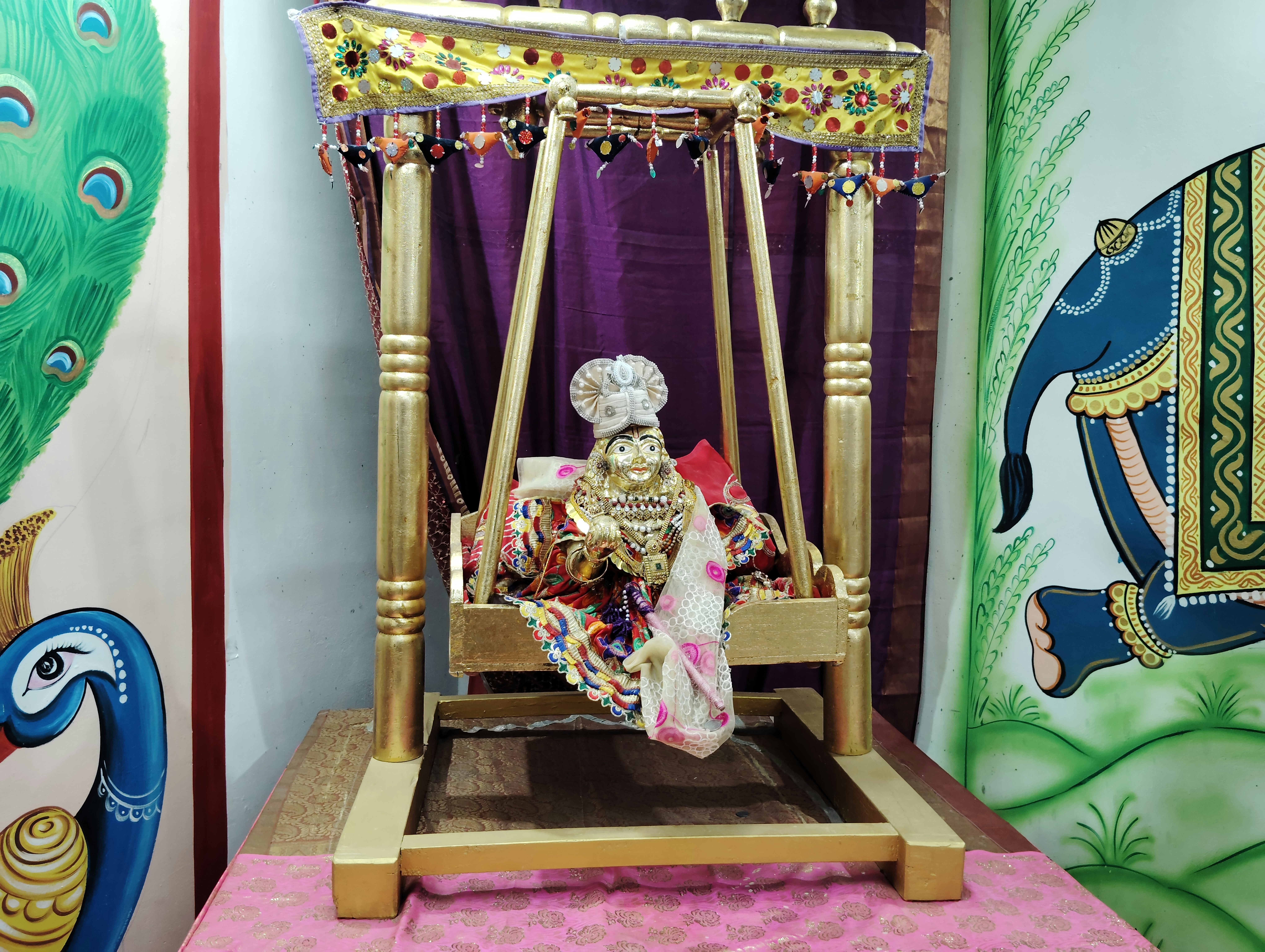 A small shrine with a statue of a person on it