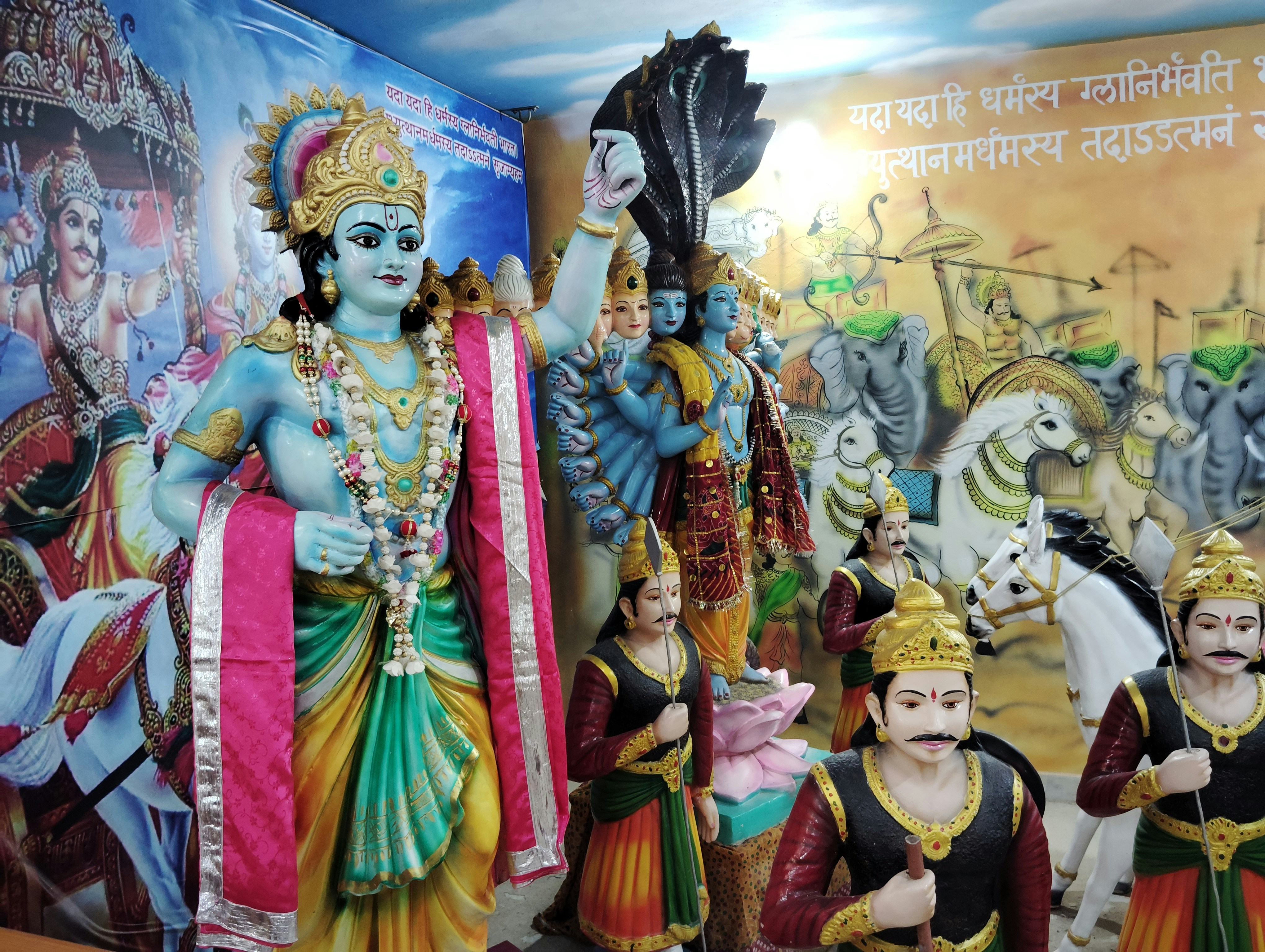 A group of statues of deities in a room