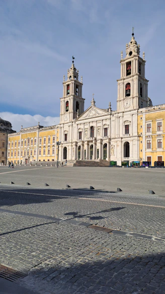 A large building with a clock tower in front of it