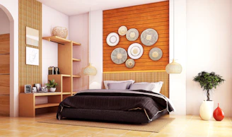 A bedroom with a bed, shelves and a plant