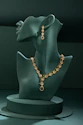 A green mannequin with a necklace on it