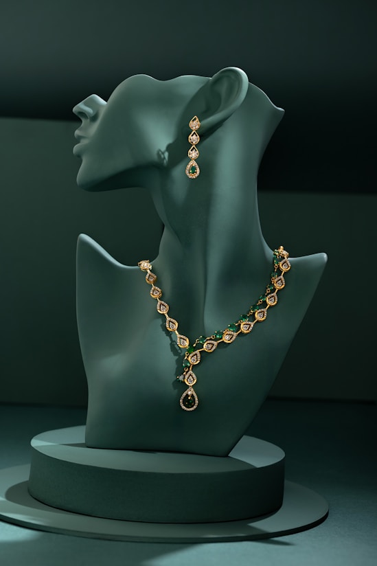 A green mannequin with a necklace on it