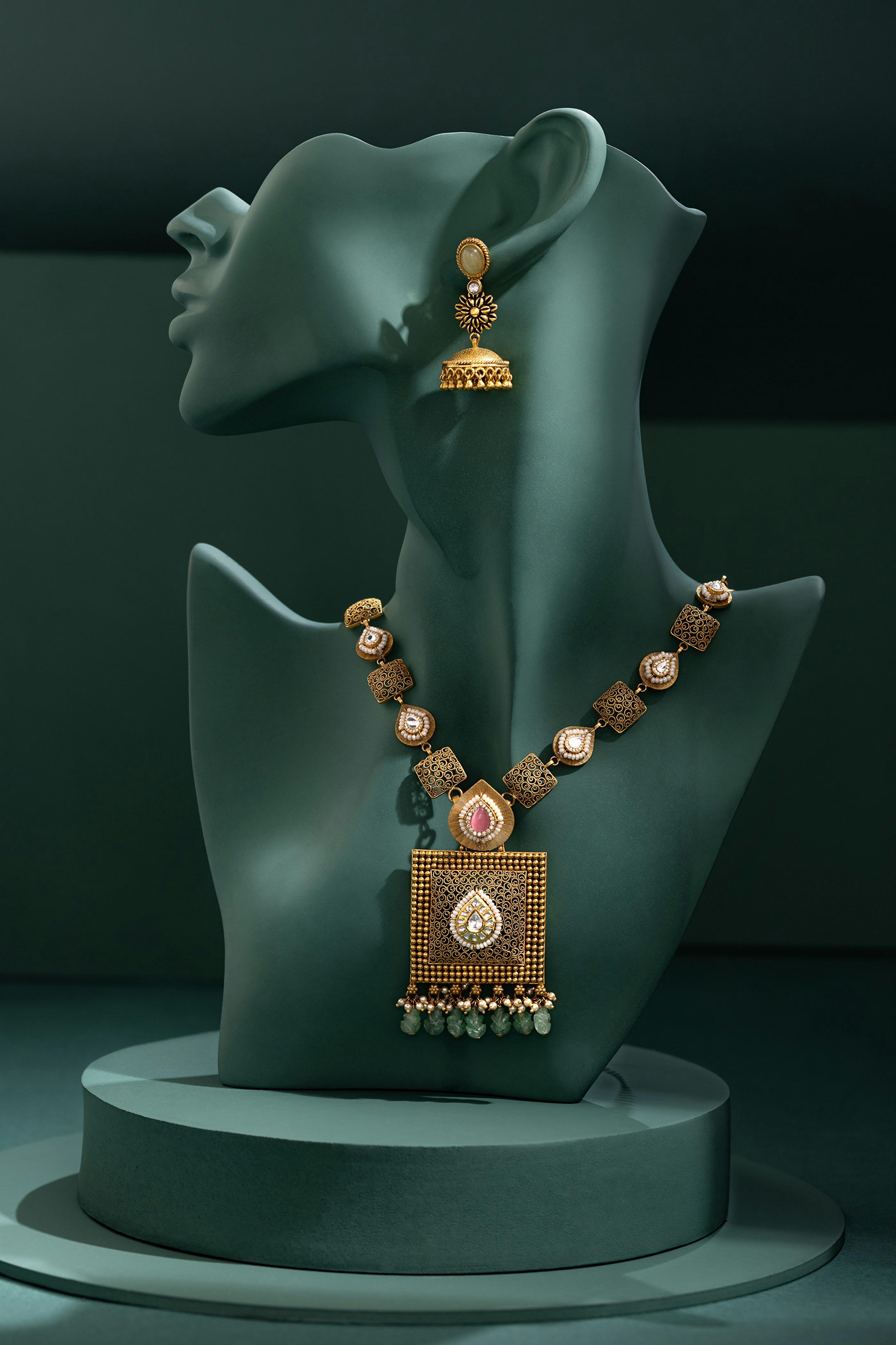 A mannequin with a necklace and earrings on display