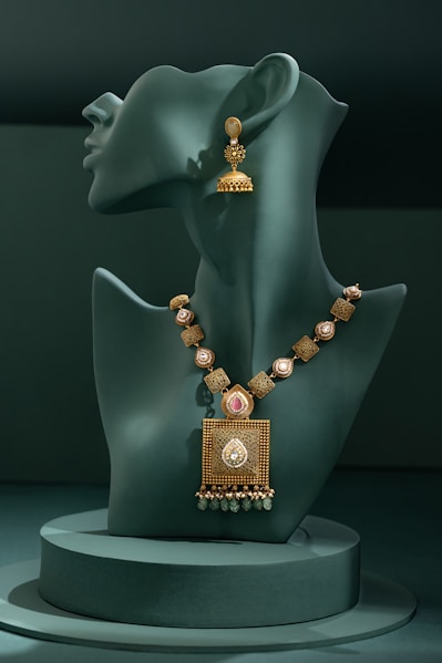 A mannequin with a necklace and earrings on display