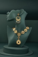 A necklace and earring on display on a mannequin