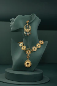 A necklace and earring on display on a mannequin