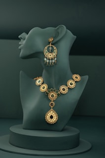A necklace and earring on display on a mannequin