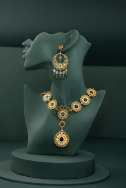 A necklace and earring on display on a mannequin