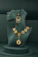 A necklace and earring on display on a mannequin