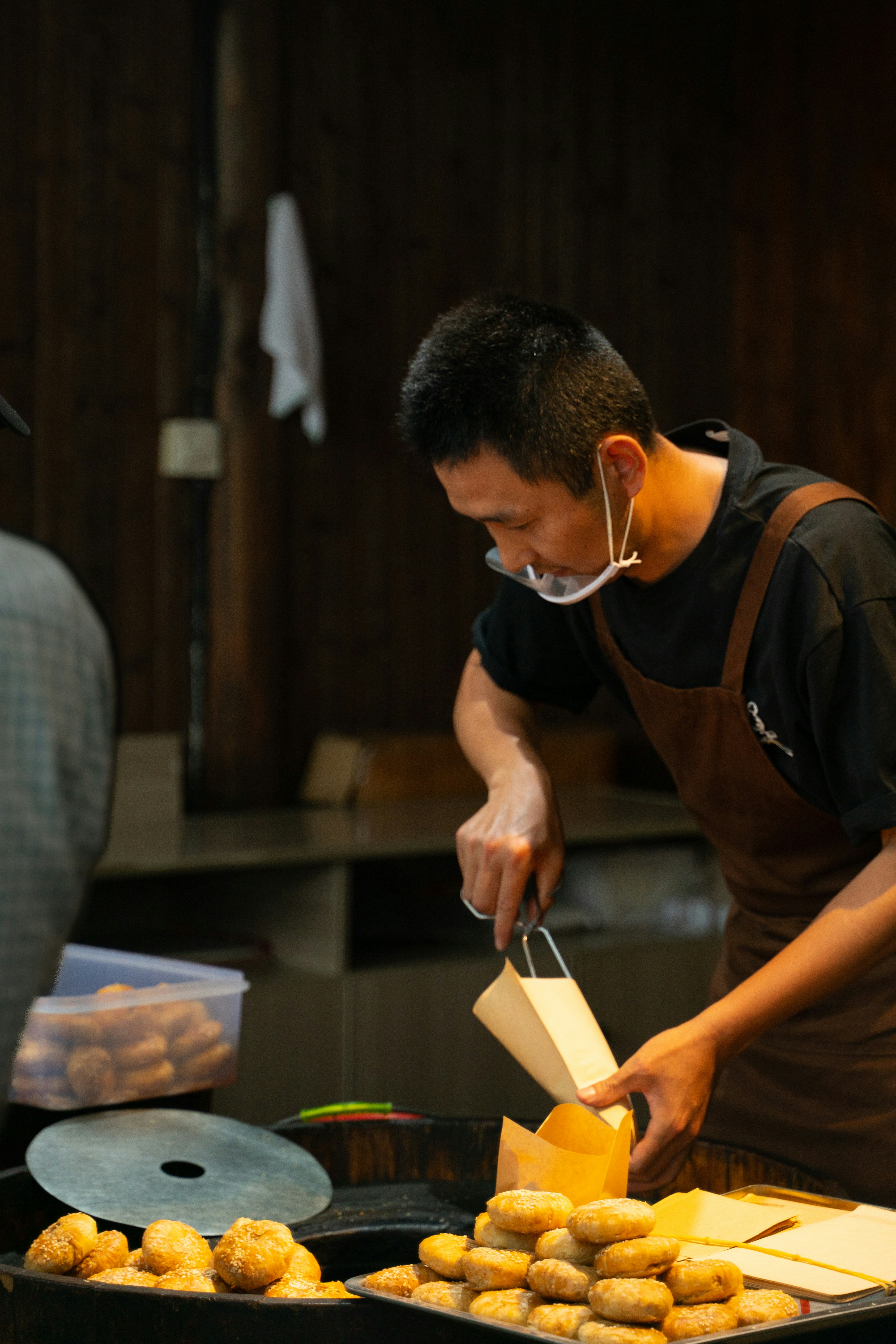 A man preparing food on a grill in a kitchen