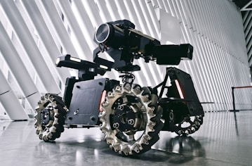 A black and white photo of a camera on wheels