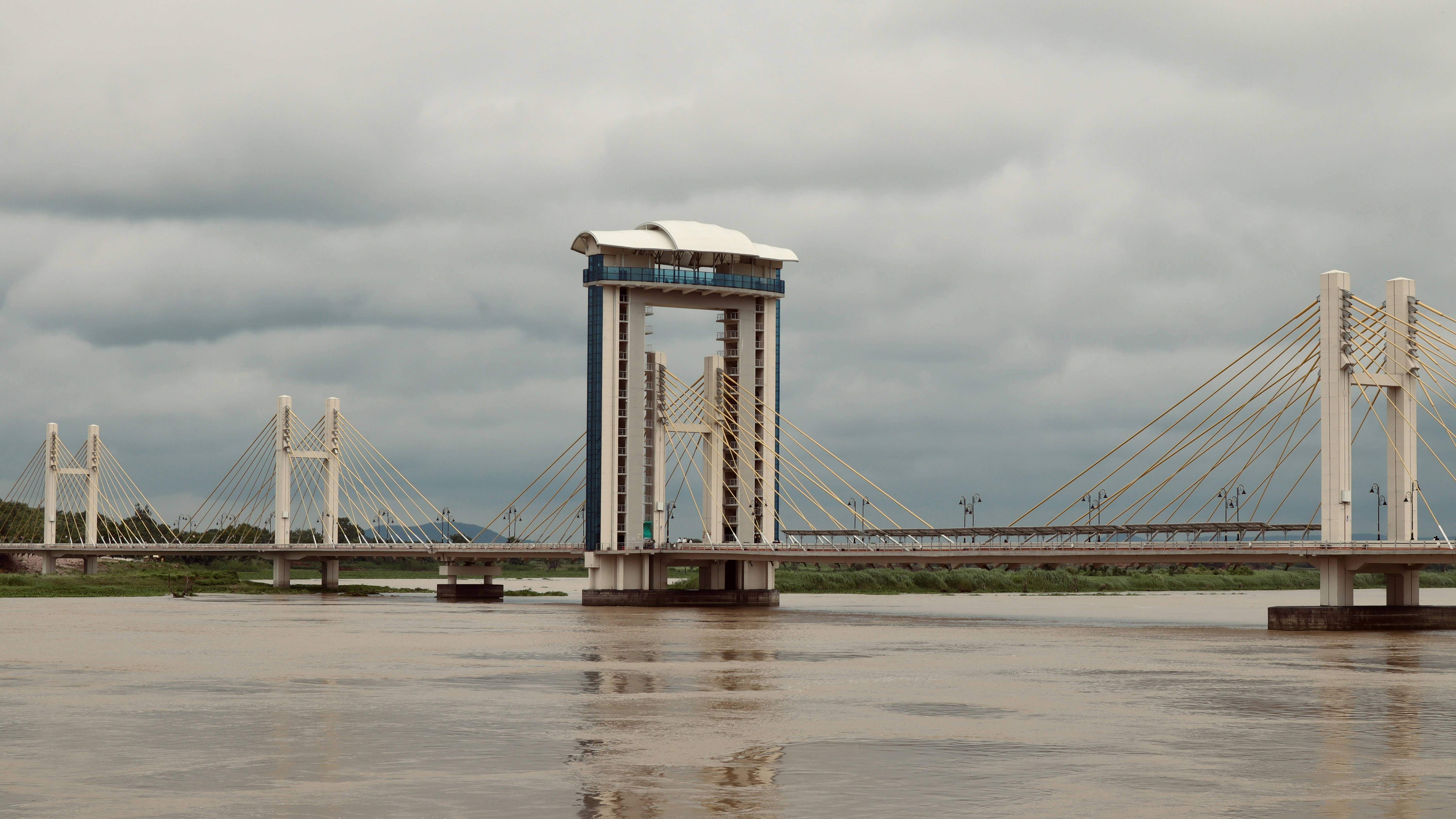 A bridge that has a tower in the middle of it